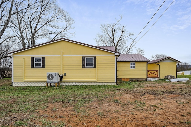 back of house with ac unit