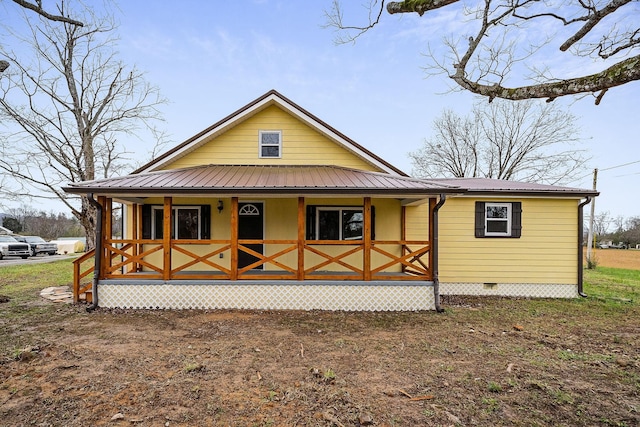 back of house featuring a porch