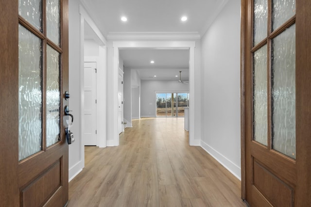 foyer entrance featuring ceiling fan, light hardwood / wood-style floors, and crown molding