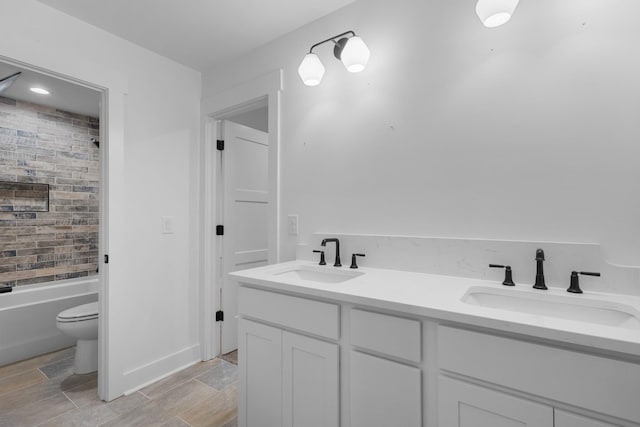 full bathroom featuring toilet, vanity, and shower / bath combination