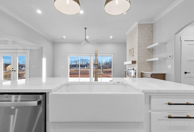 kitchen with light stone countertops, dishwasher, white cabinets, ceiling fan, and sink