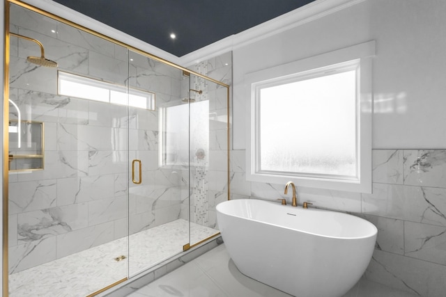 bathroom featuring tile walls, shower with separate bathtub, and ornamental molding