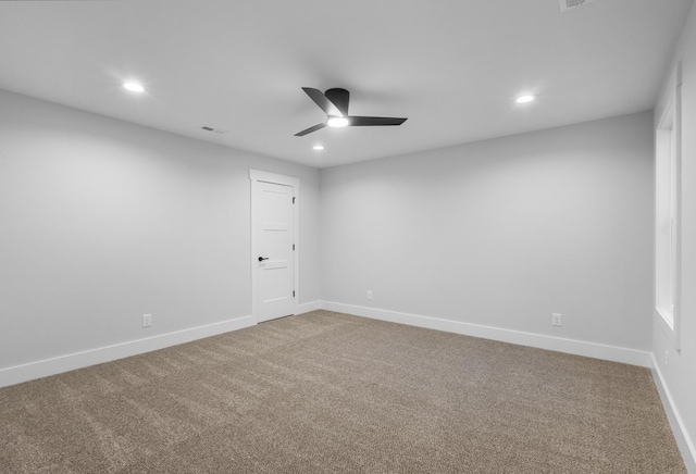 spare room featuring carpet floors and ceiling fan