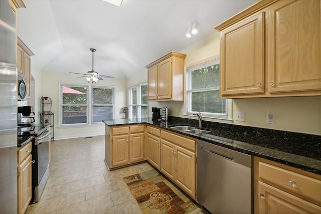 kitchen featuring stainless steel appliances, light brown cabinets, sink, and kitchen peninsula