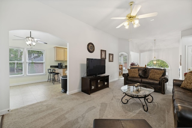 carpeted living room with ceiling fan