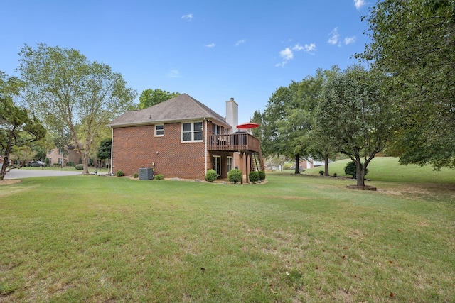 back of house featuring a lawn, a deck, and central AC unit