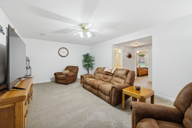 carpeted living room with ceiling fan