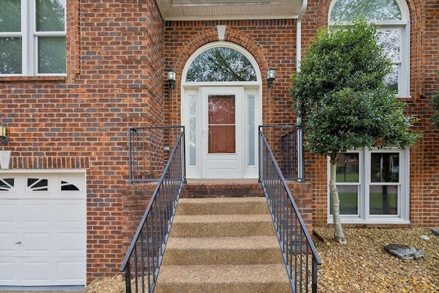 view of exterior entry with a garage