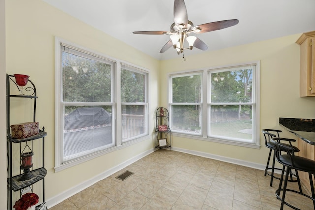 tiled dining room with ceiling fan and a wealth of natural light