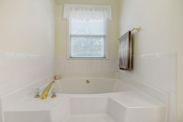 bathroom with a tub to relax in