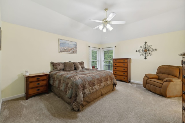 bedroom with lofted ceiling, light colored carpet, and ceiling fan