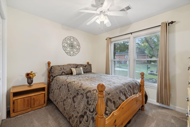 carpeted bedroom featuring multiple windows and ceiling fan