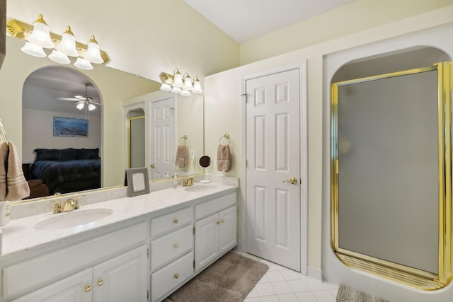 bathroom with ceiling fan, tile patterned flooring, an enclosed shower, and vanity