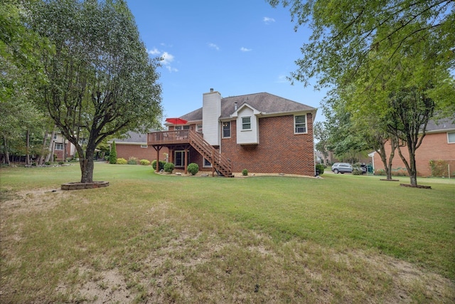 back of property with a lawn and a deck