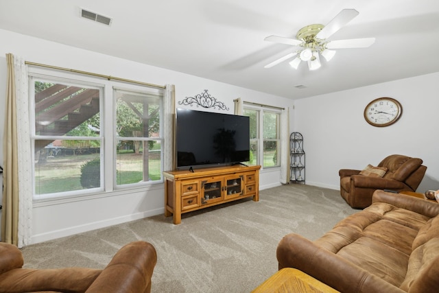 carpeted living room featuring ceiling fan and a healthy amount of sunlight