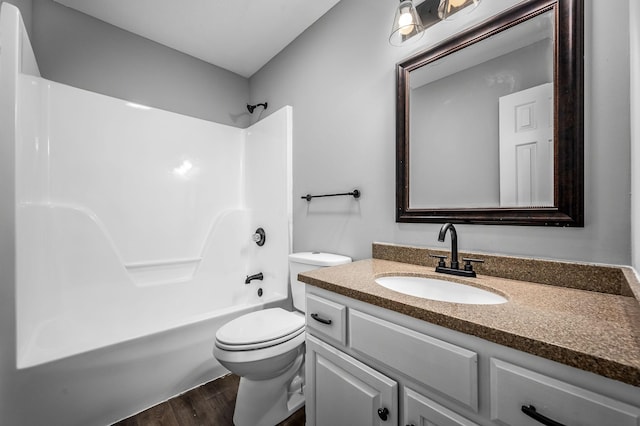 full bathroom featuring vanity, toilet, washtub / shower combination, and wood-type flooring