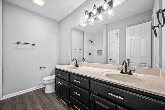 bathroom with toilet, a shower, wood-type flooring, and vanity