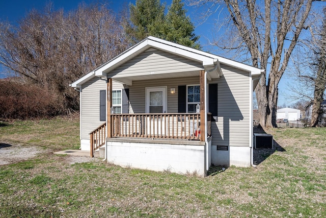 bungalow with a porch and a front lawn