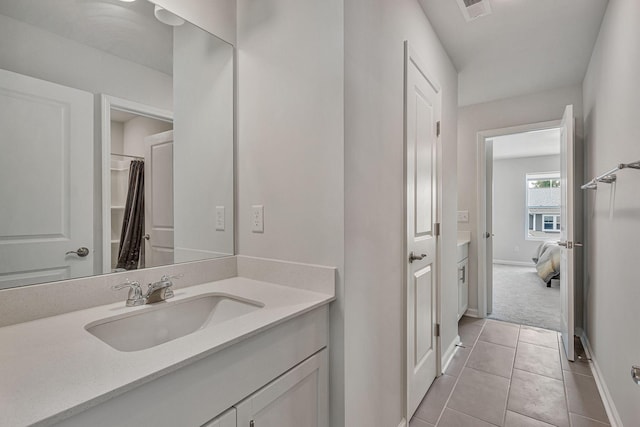 bathroom featuring tile patterned flooring and vanity