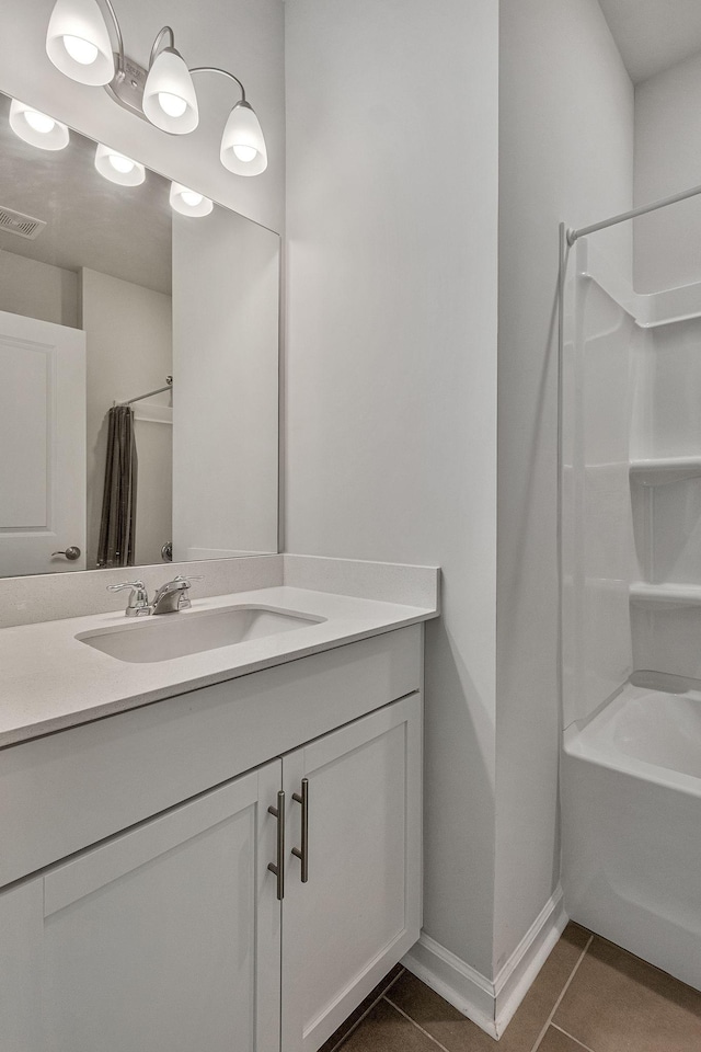 bathroom featuring tile patterned flooring, shower / tub combo with curtain, and vanity