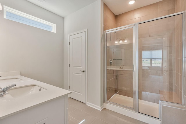 bathroom with vanity, a shower with door, and tile patterned flooring