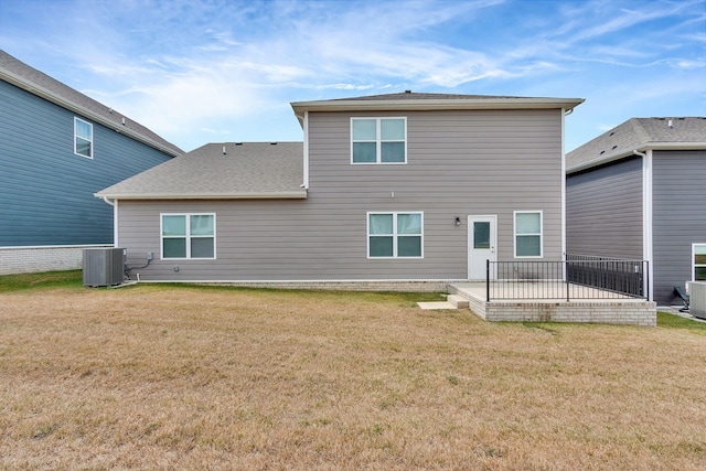 rear view of house featuring a patio area, central AC unit, and a lawn