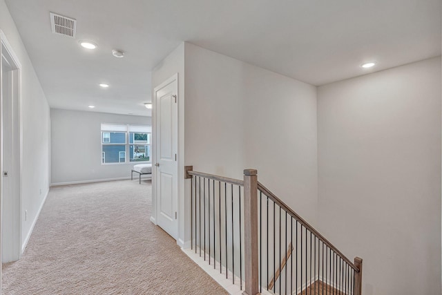 hallway featuring light carpet