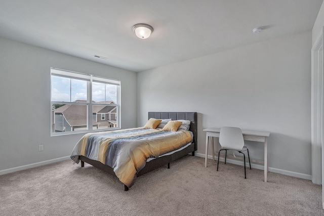 bedroom featuring light colored carpet