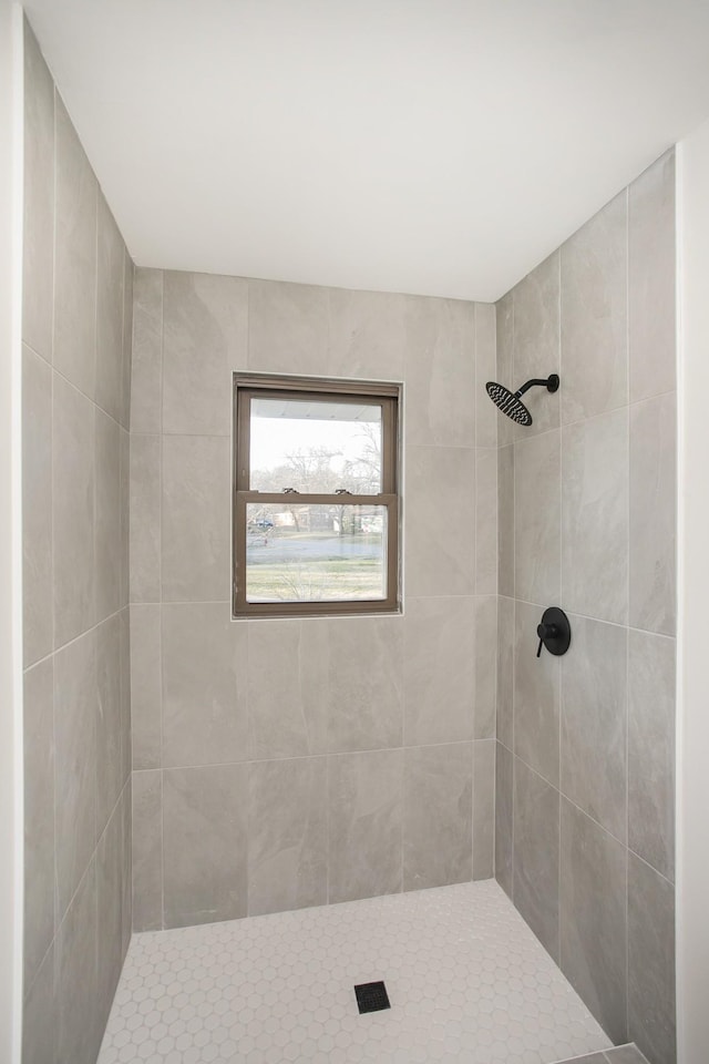 bathroom with a tile shower