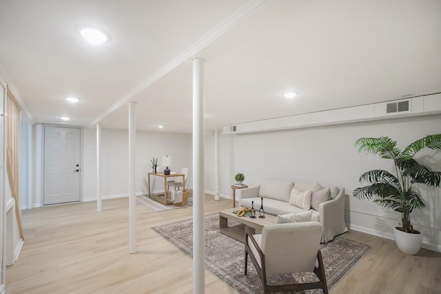 living room with light hardwood / wood-style floors and ornamental molding