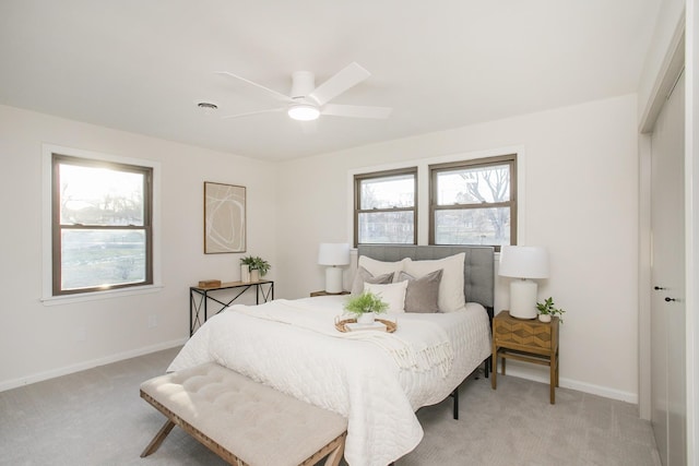 bedroom featuring light carpet, a closet, and ceiling fan