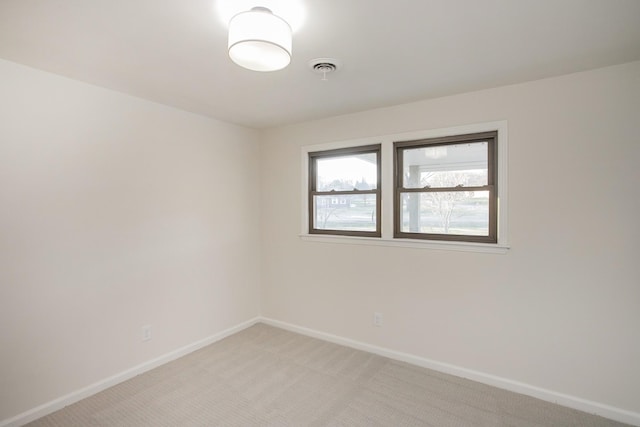 empty room featuring light carpet