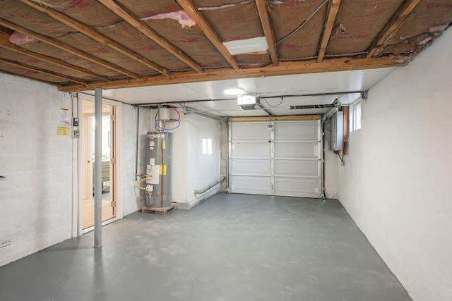 garage with a garage door opener and water heater