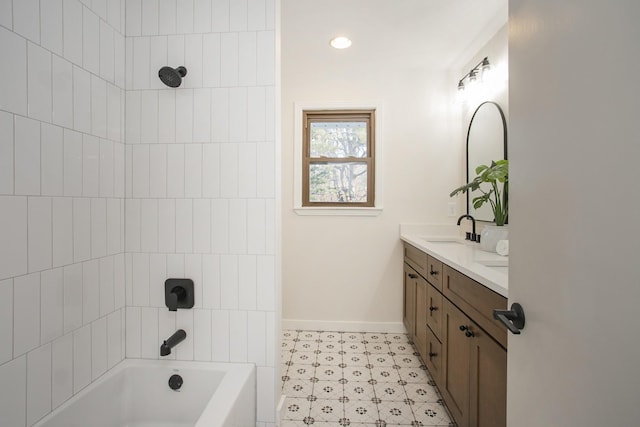 bathroom featuring tiled shower / bath combo and vanity