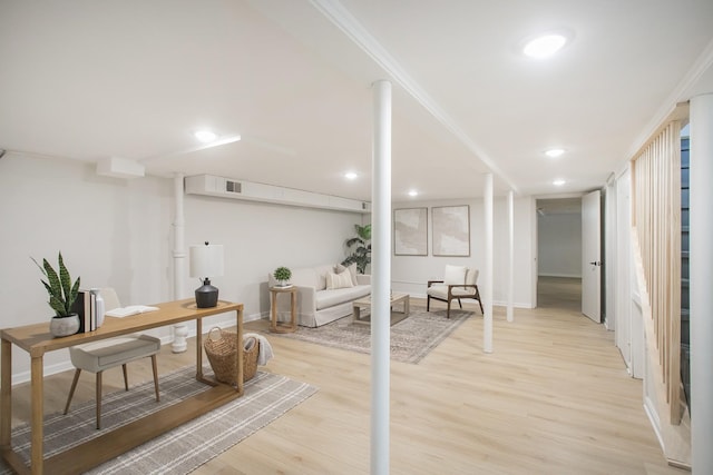 interior space with light wood-type flooring and crown molding