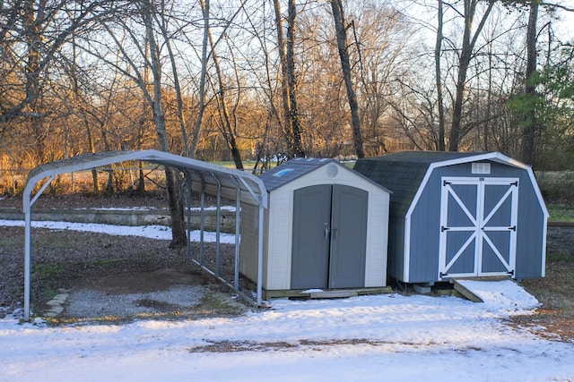 snow covered structure with a carport