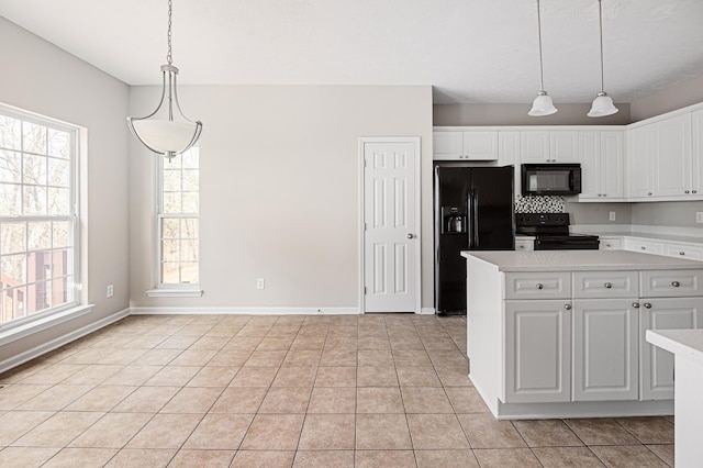 kitchen with black appliances, hanging light fixtures, white cabinets, and light tile patterned flooring