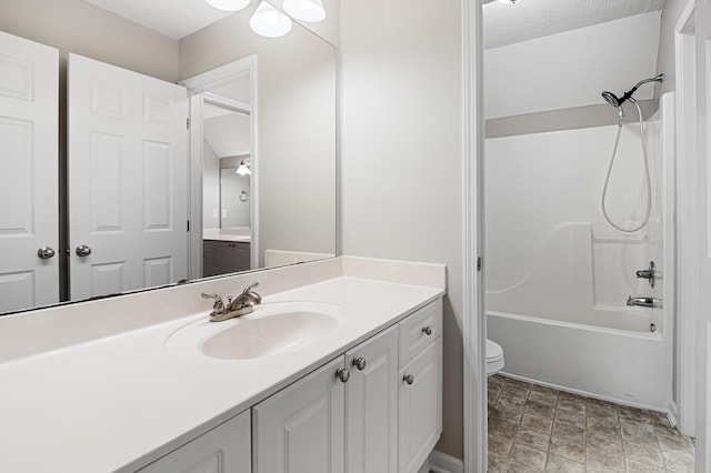 full bathroom featuring shower / bath combination, vanity, and toilet