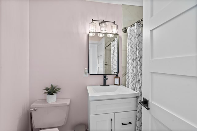 bathroom featuring toilet, curtained shower, and vanity