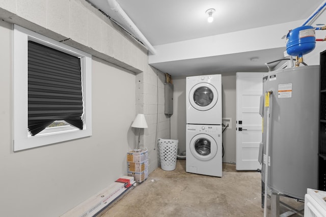 laundry room featuring stacked washer and clothes dryer and electric panel