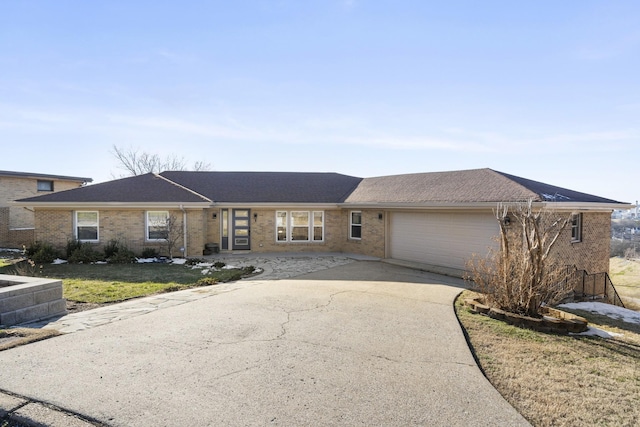 ranch-style home with a garage and a front lawn