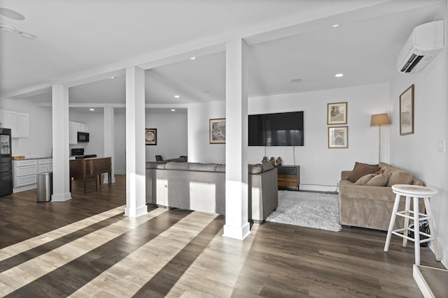 living room with a wall mounted AC and dark wood-type flooring