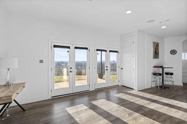 entryway with dark wood-type flooring and french doors