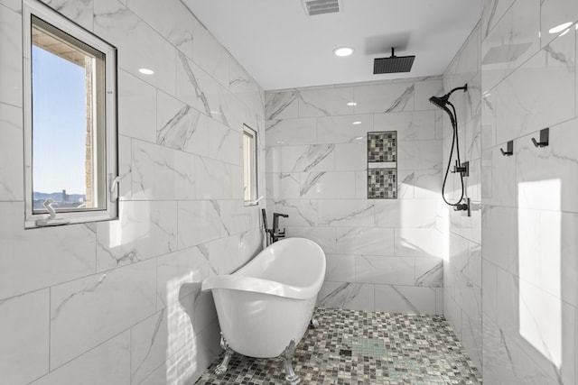 bathroom featuring tile walls and shower with separate bathtub