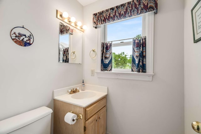 bathroom featuring toilet and vanity