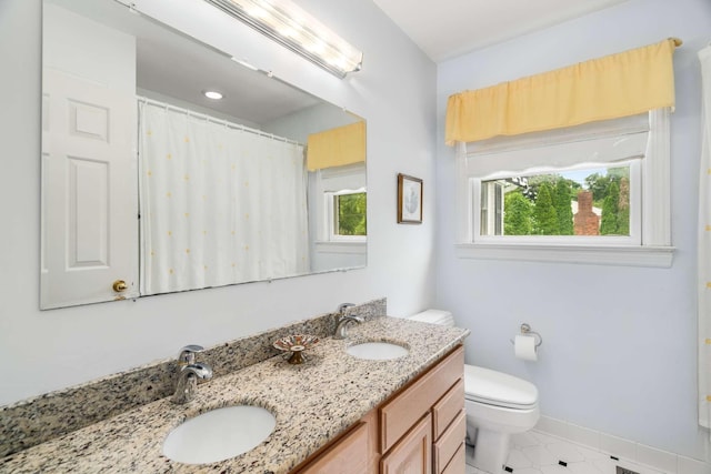 bathroom featuring toilet and vanity