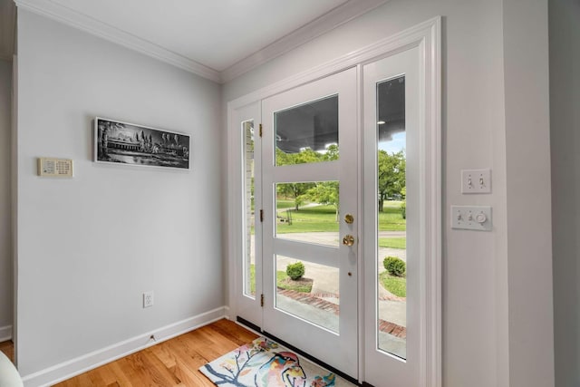 entryway with light wood-type flooring and crown molding