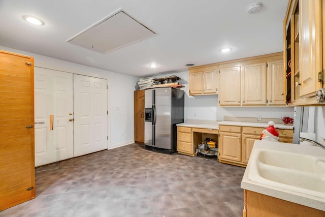 kitchen featuring sink, light brown cabinets, and stainless steel fridge with ice dispenser