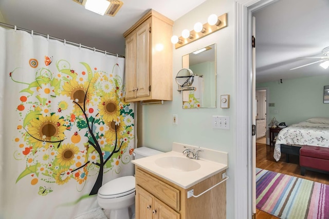 bathroom with toilet, ceiling fan, and vanity