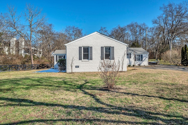 rear view of property featuring a yard